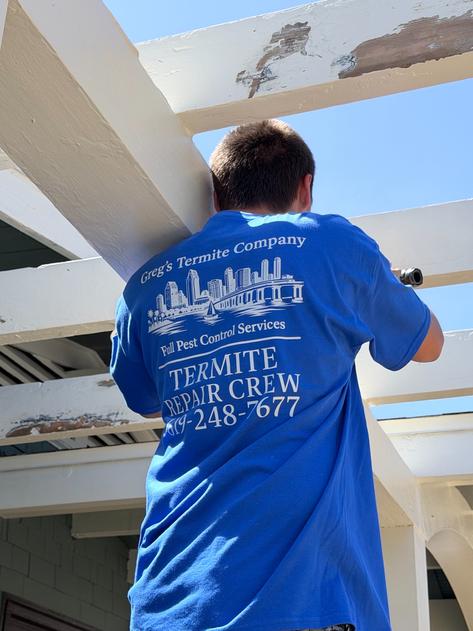 Greg’s Termite Company technician completing repair work